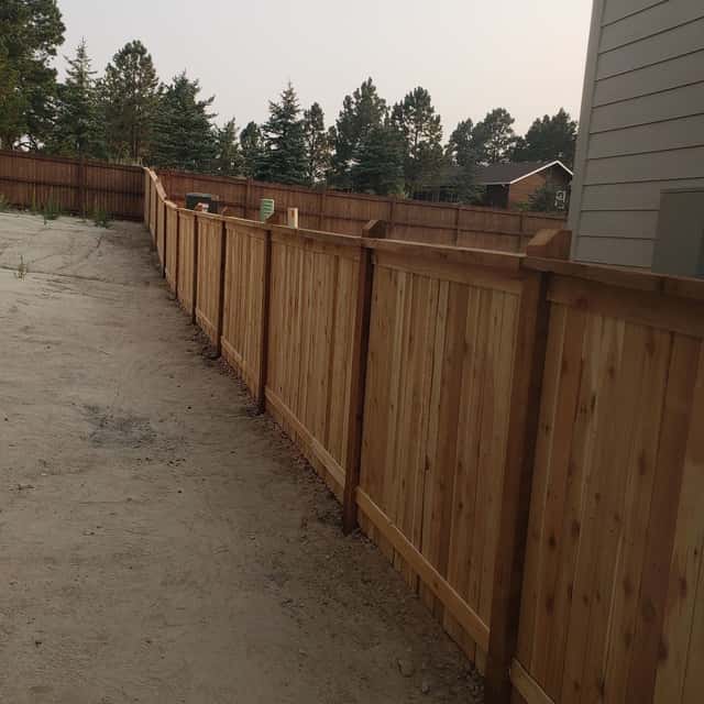 Cedar privacy fence running the length of a side yard — Angel's Landscaping LLC, Castle Rock, CO
