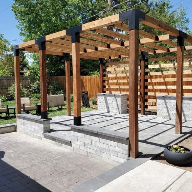 Cedar pergola on steel bases over a paver patio with seat walls — Angel's Landscaping LLC, Castle Rock, CO