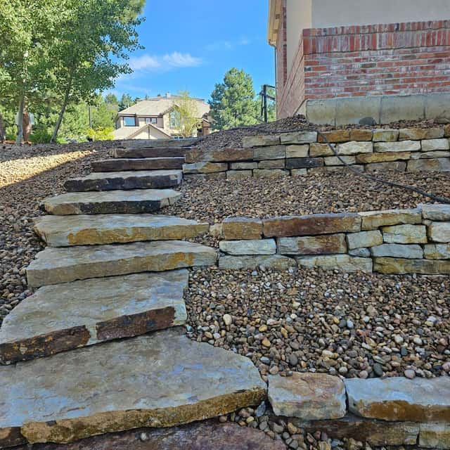 Natural stone steps set into a slope with boulder walls — Angel's Landscaping LLC, Castle Rock, CO